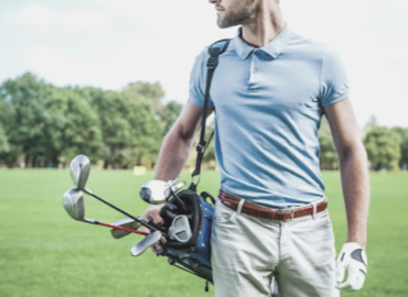 Pain and discomfort in golf, male golfer carrying bag